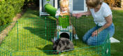 Rodzina bawiąca się ze swoim królikiem w kojcu Zippi.